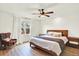 Bright bedroom featuring a ceiling fan and large window, wooden furniture, and ample light at 11575 Wilson Cir, Parker, CO 80134