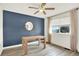 Dining Room features a stylish blue accent wall, wood table, and natural lighting at 11575 Wilson Cir, Parker, CO 80134