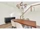 Modern dining room with wood table, chandelier, and staircase at 11575 Wilson Cir, Parker, CO 80134