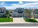 An aerial view of a well-maintained house with an attached three-car garage and lush greenery at 11575 Wilson Cir, Parker, CO 80134