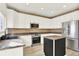 Modern kitchen boasts white cabinets, granite countertops, and stainless steel appliances at 11575 Wilson Cir, Parker, CO 80134