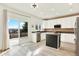 Sunlit kitchen featuring white cabinets, stainless steel appliances, and deck access at 11575 Wilson Cir, Parker, CO 80134