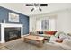 Inviting living room featuring a cozy fireplace, large windows, and a sectional sofa at 11575 Wilson Cir, Parker, CO 80134