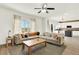 An open-concept living room featuring an attached kitchen and plenty of natural light at 11575 Wilson Cir, Parker, CO 80134