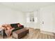 A bright living room boasts hardwood floors, large windows, and a comfortable sofa at 11575 Wilson Cir, Parker, CO 80134