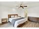 Bright main bedroom boasts wood accents and a view to an ensuite bathroom with a glass enclosed shower at 11575 Wilson Cir, Parker, CO 80134