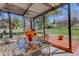 Outdoor patio area features a glass table and chairs with backyard views at 7420 Windwood Way, Parker, CO 80134