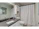 Bathroom featuring dark countertop, large mirror, and neutral colors at 7420 Windwood Way, Parker, CO 80134