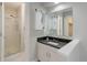 Bathroom featuring modern vanity, large mirror, and tiled glass door shower at 7420 Windwood Way, Parker, CO 80134