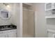 Bathroom with a white sink vanity, decorative mirror, shower, and white cabinet at 7420 Windwood Way, Parker, CO 80134