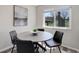 Dining area offers a round table with seating for four and a window with backyard views at 7420 Windwood Way, Parker, CO 80134