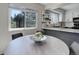 Eat-in kitchen features modern table and chairs and a window offering natural light and outdoor views at 7420 Windwood Way, Parker, CO 80134