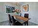 Cozy dining area featuring bright lighting, dark table and access to the living room at 7420 Windwood Way, Parker, CO 80134