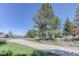 Residential street view, showcases curb appeal and surrounding neighborhood landscaping at 7420 Windwood Way, Parker, CO 80134