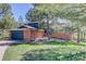 Charming home with a brick exterior, blue siding, mature trees and a well-manicured lawn at 7420 Windwood Way, Parker, CO 80134