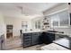 Bright kitchen offers sleek cabinetry, subway tile, stainless steel appliances, and marble countertops at 7420 Windwood Way, Parker, CO 80134
