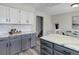 Well-lit kitchen featuring gray and white cabinetry, marble countertops and subway tile backsplash at 7420 Windwood Way, Parker, CO 80134