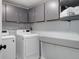 Laundry room featuring modern washer, dryer, built in shelving and countertop at 7420 Windwood Way, Parker, CO 80134