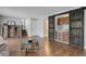 Open-concept living room with hardwood floors, sliding barn door, and natural light at 7420 Windwood Way, Parker, CO 80134