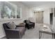 Comfortable living room featuring soft carpet, bright windows, and convenient access to the home's foyer at 7420 Windwood Way, Parker, CO 80134