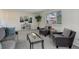 Cozy living room features soft neutral carpet, bright windows, and comfortable decor at 7420 Windwood Way, Parker, CO 80134