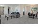 Open-concept living space with a comfortable couch, a nearby dining table, and the home's foyer at 7420 Windwood Way, Parker, CO 80134