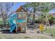 Fun backyard playground features a blue slide, swing set, and wooden playhouse at 7420 Windwood Way, Parker, CO 80134