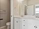 Bright bathroom featuring a double vanity with white cabinets and modern fixtures at 6824 Huddersfield Ln, Castle Pines, CO 80108