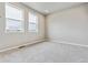 Bedroom featuring two large windows, light gray walls and light gray carpet at 6824 Huddersfield Ln, Castle Pines, CO 80108