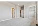 Bedroom featuring light gray walls and carpet along with access to the bathroom and closet at 6824 Huddersfield Ln, Castle Pines, CO 80108