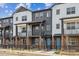 Charming townhomes with two-tone exteriors, inviting balconies, and well-maintained landscaping at 6824 Huddersfield Ln, Castle Pines, CO 80108