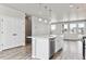 Bright kitchen with an island, stainless steel dishwasher and hardwood style flooring at 6824 Huddersfield Ln, Castle Pines, CO 80108