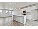 Open-concept kitchen with a large island, pendant lighting, and stainless steel appliances at 6824 Huddersfield Ln, Castle Pines, CO 80108