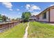 Well-maintained backyard with lush lawn offers plenty of space for recreation and gardening at 9015 W Tanforan Dr, Littleton, CO 80123