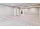 Spacious basement with neutral carpet and paint, with multiple closets and access to additional rooms at 9015 W Tanforan Dr, Littleton, CO 80123