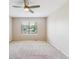 This light and bright bedroom has neutral paint and carpet, ceiling fan, and a window at 9015 W Tanforan Dr, Littleton, CO 80123