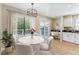 Cozy breakfast nook with marble table, bright natural light, and adjacent workspace at 9015 W Tanforan Dr, Littleton, CO 80123