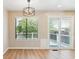 Light-filled dining area with modern light fixture and sliding glass door to deck at 9015 W Tanforan Dr, Littleton, CO 80123