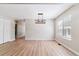 Bright dining room featuring modern lighting, neutral colors and light wood floors at 9015 W Tanforan Dr, Littleton, CO 80123