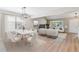 Bright and airy living room with modern furniture and a dining area with stylish chandelier at 9015 W Tanforan Dr, Littleton, CO 80123