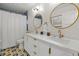 Bathroom with double vanity, white cabinets, and gold accents at 5965 W Quarles Dr, Littleton, CO 80128