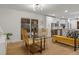 Modern dining room with glass table and gold chairs at 5965 W Quarles Dr, Littleton, CO 80128