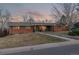 Brick ranch house with a landscaped lawn and walkway at 5965 W Quarles Dr, Littleton, CO 80128