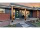 Inviting front porch with a green door and wooden posts at 5965 W Quarles Dr, Littleton, CO 80128