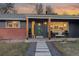 Modern front porch with green door and stone walkway at 5965 W Quarles Dr, Littleton, CO 80128