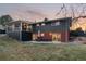 Back exterior view of house showing deck, patio, and landscaping at 5965 W Quarles Dr, Littleton, CO 80128