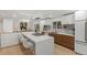 Modern kitchen with white cabinets and an island at 5965 W Quarles Dr, Littleton, CO 80128