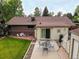 Aerial view of backyard featuring a patio, chairs, and green lawn at 9115 W 5Th Ave, Lakewood, CO 80226