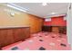 Finished basement with tile flooring, wood paneling, and built-in storage at 9115 W 5Th Ave, Lakewood, CO 80226
