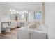 Bright bathroom with white cabinets, and jacuzzi tub at 9115 W 5Th Ave, Lakewood, CO 80226